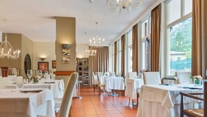 A restaurant with multiple tables, chairs, and a large window with curtains. - Countryside home in Foligno (Foligno)