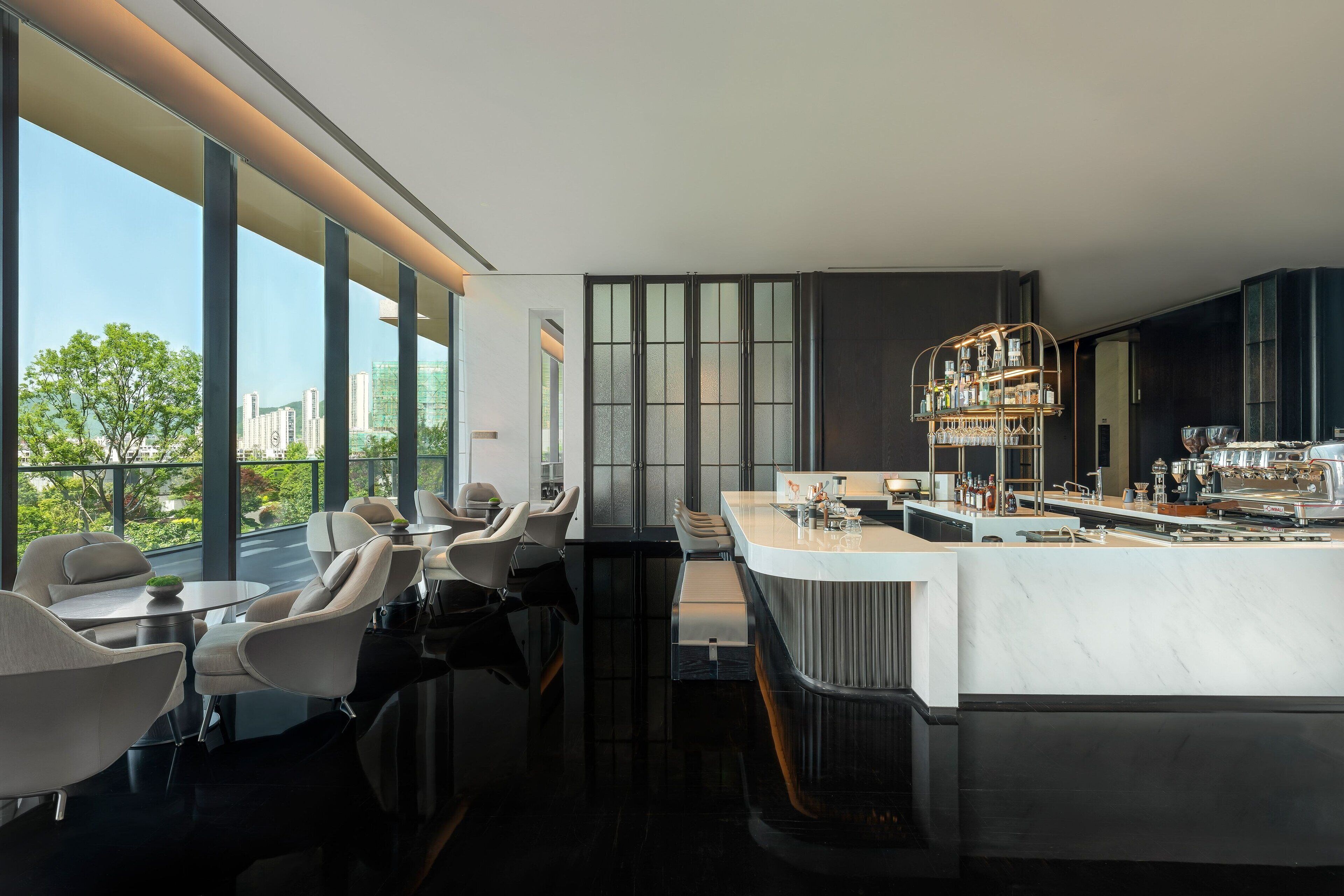 A modern bar area with a bar counter and seating.
