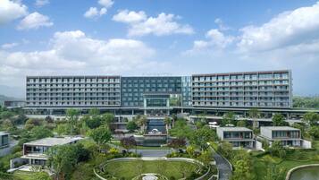 A modern hotel with a central courtyard, multiple floors, and a prominent 'Sheraton' sign.