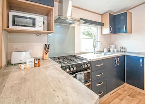 Fridge, oven, stovetop, toaster - 12ft-wide caravan with one double with en suite bathroom and one twin bedroom. (Milford-on-Sea, Nr Lymington)