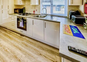 Oven, dishwasher, coffee/tea maker, dining tables