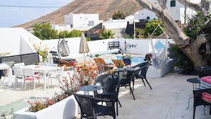 A rooftop terrace with outdoor seating, a pool, and a mountain view. - GA7COLORES (San Bartolome)