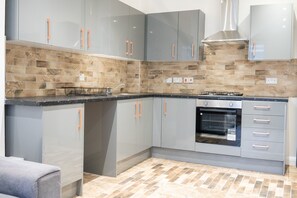 Departamento Deluxe | Cocineta privada | Refrigerador con congelador, microondas, horno y parrilla de estufa 