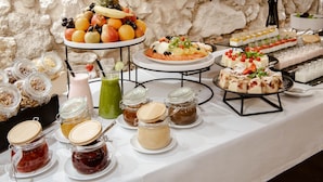 A buffet table with various food items and condiments. - N33 Premium Apartments Old Town Kraków – Destigo Hotels (Kraków)