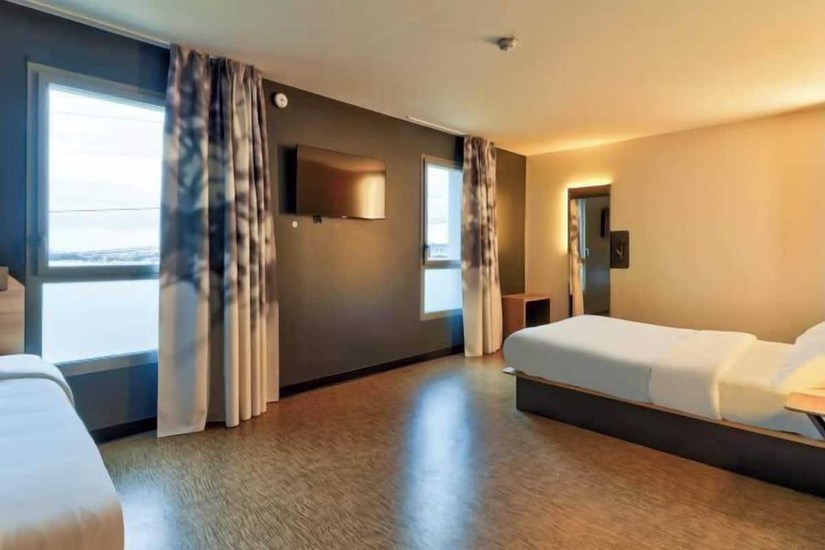 Premium bedding, desk, laptop workspace, blackout curtains