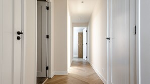 A hallway with white doors and wooden flooring. - Dunefront Apartment - A perfect getaway location! (Zandvoort)
