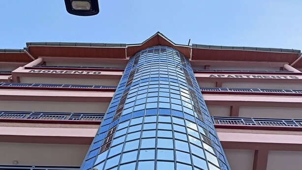 A tall building with a glass facade and balconies. - Serene 2 bedroom apartment in the heart of Nakuru (Nakuru)