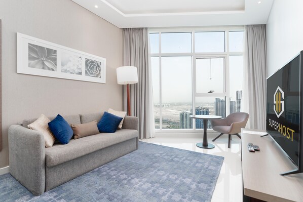 Design Apartment | Living area | 55-inch Smart TV with cable channels, TV - SuperHost - Breathtaking Canal Views From this Cozy Apartment (Dubai)
