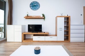 Superior Family Apartment with Balcony | Living area | 50-inch flat-screen TV with digital channels, TV
