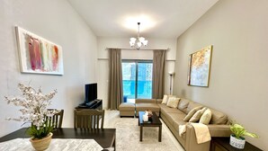 Design Apartment | Living area | 55-inch Smart TV with cable channels, TV - SuperHost - Spacious Apartment In Business Bay With Canal View (Dubai)