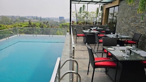 An outdoor pool area with a clear view of the cityscape. - Quality Inn Rockwell Grand, Bangalore (Bengaluru)