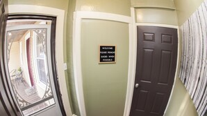 A hallway with a welcome sign, a door, and a view of the outside. - Comfortable place to work, Priced per-person rate (Vernon)