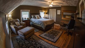 A bedroom with a bed, a chair, a desk, and a ceiling fan. - Comfortable place to work, Priced per-person rate (Vernon)
