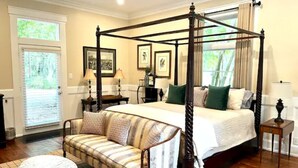 A four-poster bed with a canopy, a sofa, a round table, and a small side table. - Wedgefield Country Club  (Georgetown)