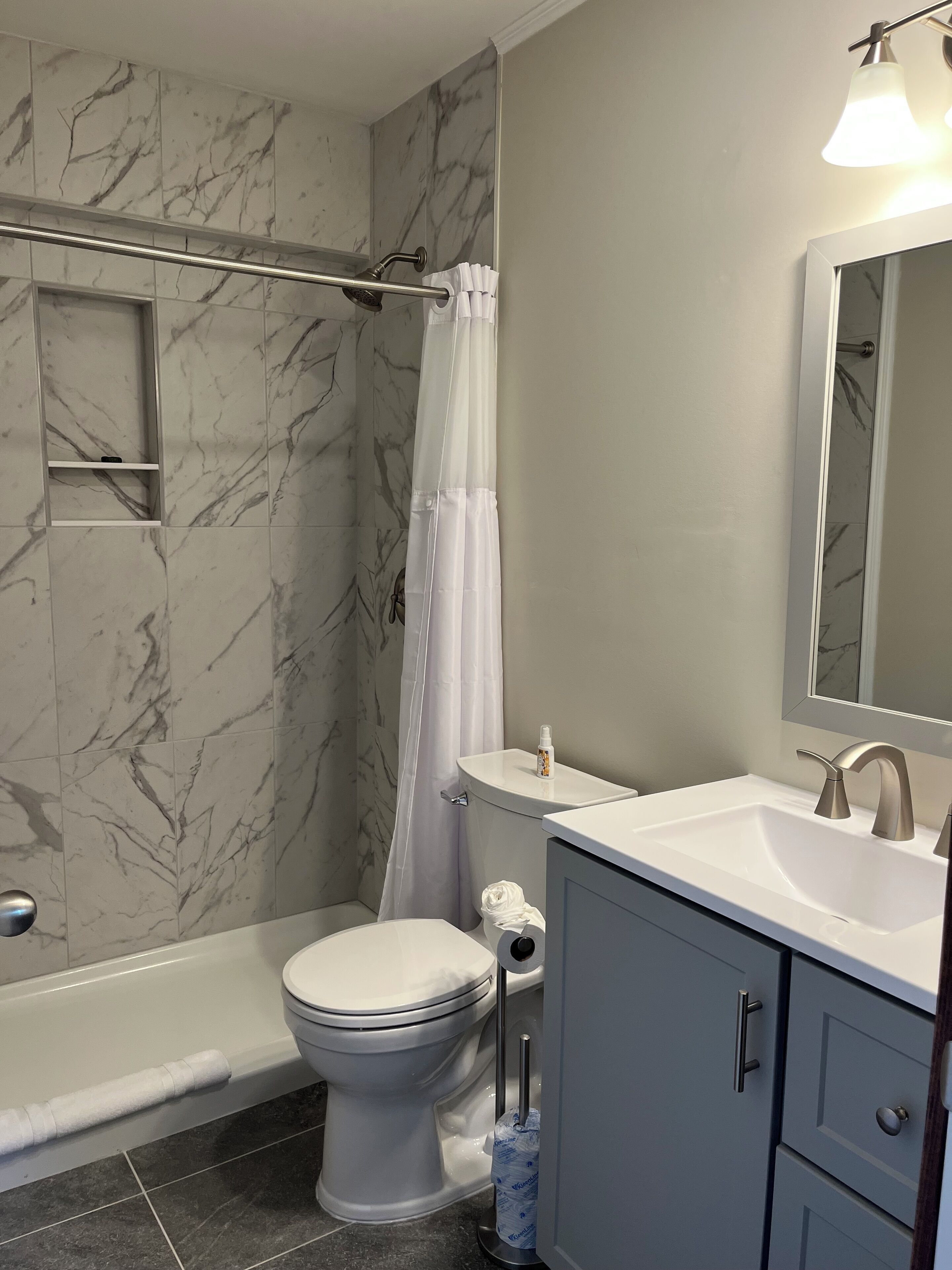 A bathroom with a bathtub, toilet, and sink.