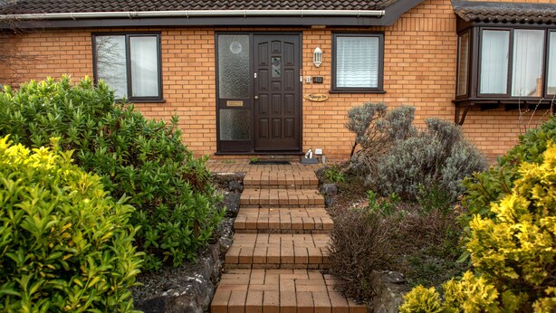 A brick house with a black front door, a small porch, and a number '40' sign. - A detached, dog-friendly bungalow with a large garden near Abergele (Abergele)
