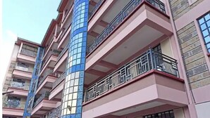A multi-story building with balconies and a distinctive blue-tiled facade. - A spacious & lovely 1 bedroom homestay in Nakuru (Nakuru)