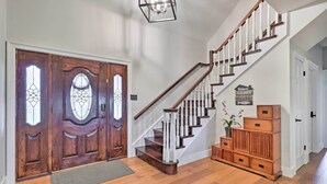 A wooden staircase with white balusters leading to a landing. - Modern Lakehouse w/ Stunning Views & Hot Tub! (Granger)