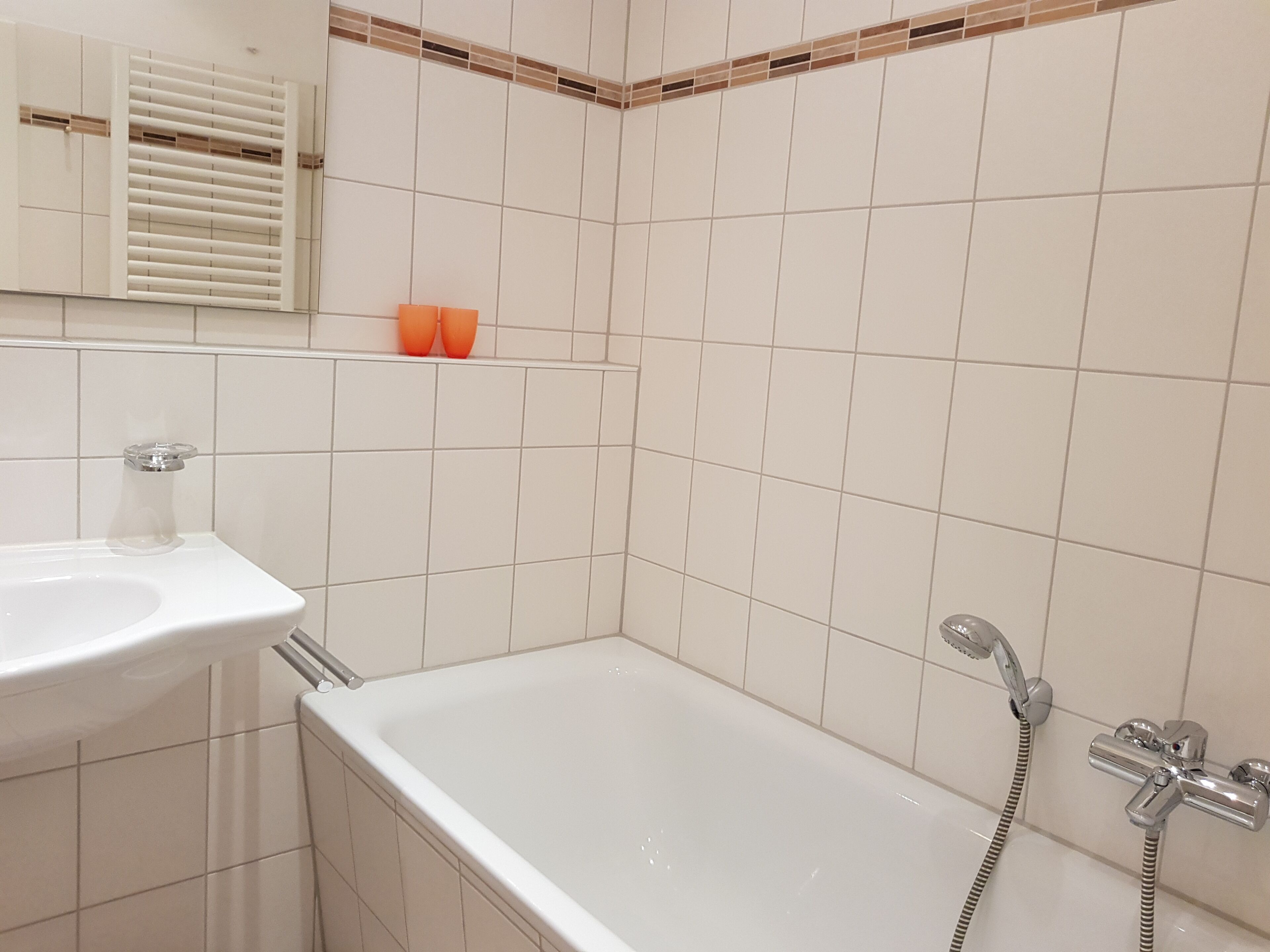 A bathroom with a bathtub, a sink, and a shower.