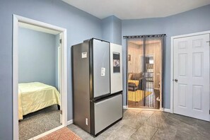Cozy apartment with a bed, kitchenette, and balcony with a view.