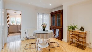 A dining area with a round table, chairs, and a cabinet. - Bright Spacious 2-bedroom Jericho House (Oxford)