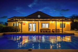 A two-story building with a swimming pool in front. - Stylish 5BR Villa | Salina Sea La Vie | Pool (Noord)