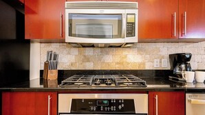 A kitchen with a microwave, stove, coffee maker, and a dishwasher. - Divi Aruba: 3BR Oasis w Free Parking near Beaches (Oranjestad)