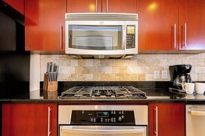 A kitchen with a microwave, stove, coffee maker, and a dishwasher. - Divi Aruba: 3BR Oasis w Free Parking near Beaches (Oranjestad)