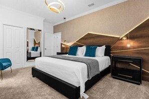 Relax in this stylish bedroom with a large bed, two nightstands, and a spacious mirror.