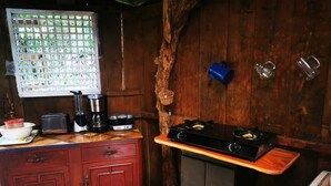 A kitchen with a wooden counter, a coffee maker, a toaster, and a stove. - Complete Cabin and Mountain Farm (San Ramon)
