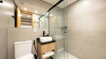 Deluxe Studio | Bathroom | Shower, hair dryer, soap, shampoo