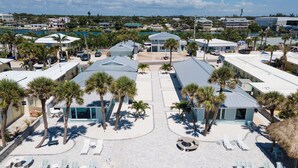 A resort with multiple buildings, palm trees, and a pool area. - Private 2 BR steps from beach on Casey Key (Nokomis)