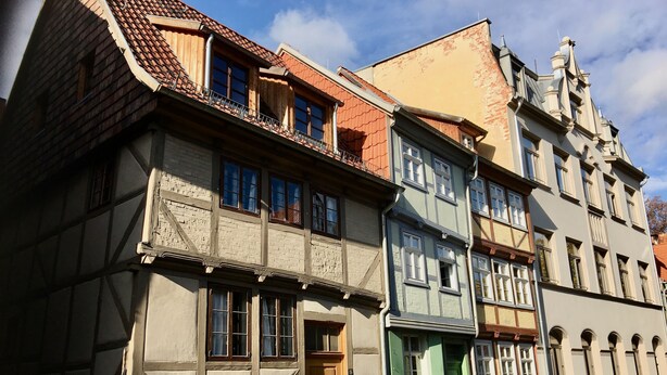 A row of traditional European buildings with timber framing and varied facades.