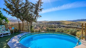 A swimming pool with a view of a valley and mountains.