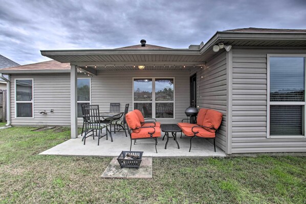 A house with a covered patio, outdoor furniture, and a grill. - Charming Louisiana Home - 21 Mi to LSU! (Denham Springs)