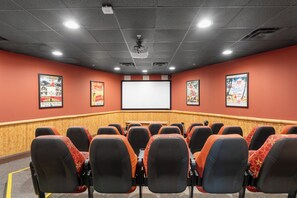 A conference room with rows of chairs, a large screen, and posters on the walls. - Origin 803: Gulf-View 1BR w/ Sunset Corner Balcony! (Panama City Beach)