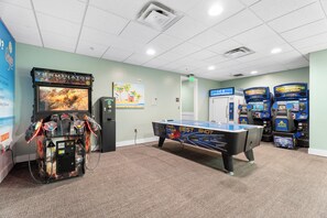 A pool table with a pool table in a room with arcade machines. - Origin 803: Gulf-View 1BR w/ Sunset Corner Balcony! (Panama City Beach)