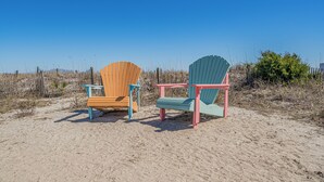 Two beach chairs on a sandy beach with a clear blue sky. - ~Tipsy Turtle~ Beautiful house in Ocean Lakes Campground with golf cart!  (Myrtle Beach)