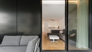 A modern living room with a grey sofa, a white coffee table, and a dark grey sectional sofa. - GuestReady - Amazing Modern home near the beach (Vila Nova de Gaia)