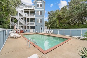 A multi-story building with a swimming pool, outdoor seating, and a staircase. - 7725- Sun Kissed - Avon Retreat | Pool, Hot Tub & Theater Room (Avon)