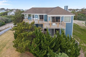 A two-story house with a balcony, a covered porch, and a garage.