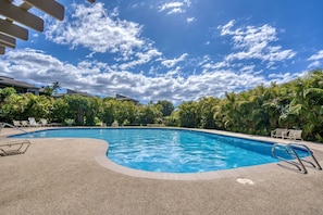 A swimming pool with a clear blue sky and clouds, surrounded by palm trees and lounge chairs. - Wailea Ekolu 206 -Gorgeous Ocean View - AC - Close to Wailea Beach! (Kihei)