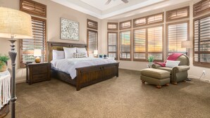 A bedroom with a large bed, a chair, a desk, and a ceiling fan. - Peace in Las Sendas W/ Heated Pool/Spa! 30 night min. (Mesa)