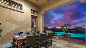 An outdoor dining area with a view of a swimming pool and sunset. - Peace in Las Sendas W/ Heated Pool/Spa! 30 night min. (Mesa)