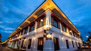 A white building with multiple windows and a sign that reads "Casa Blanca Hotel." - La Casa Blanca de Vigan Hotel (Vigan)