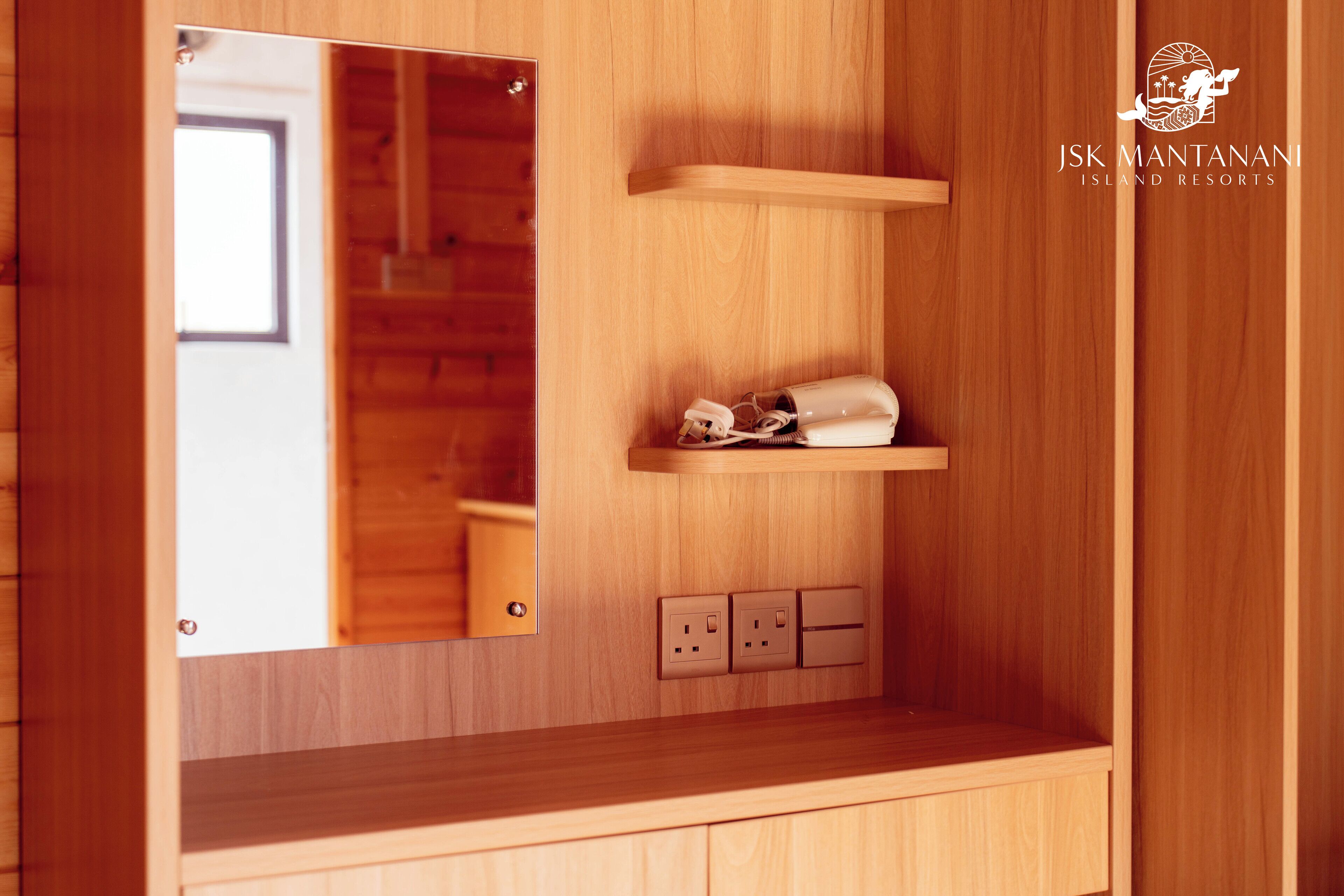 A wooden interior with a mirror, a shelf with a bag, and electrical outlets.