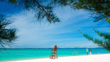On the beach, white sand, free beach cabanas, sun-loungers