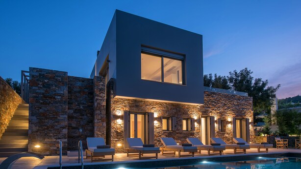 A modern building with a swimming pool, stone walls, and outdoor seating. - Luxurious Sea View Villa in Agios Nikolaos (Agios Nikolaos)