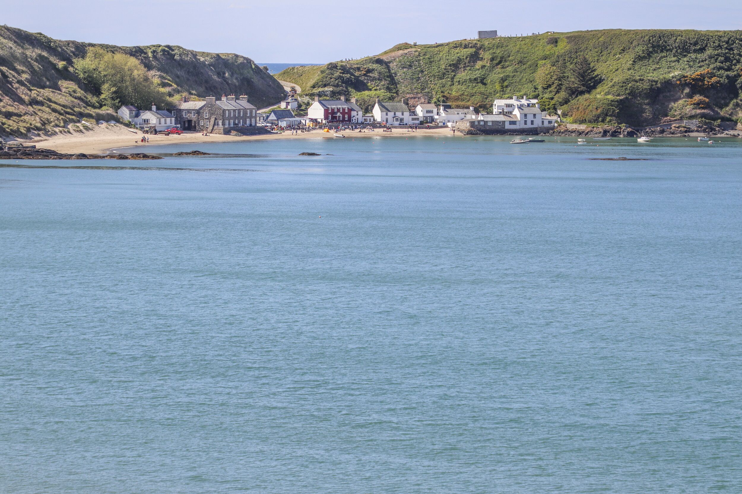 A coastal town with buildings along the shore and calm water.