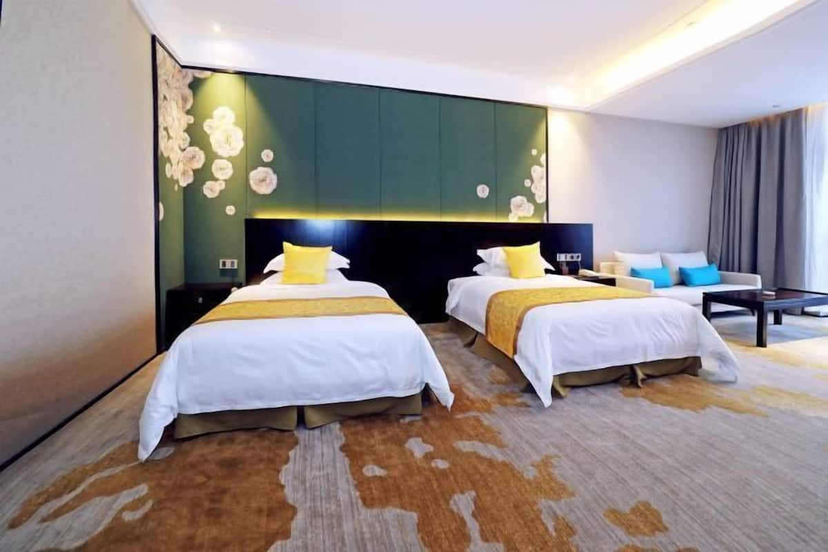 Een hotelkamer met twee bedden, een groot wanddecor, een modern hoofdeinde en een groot raam.